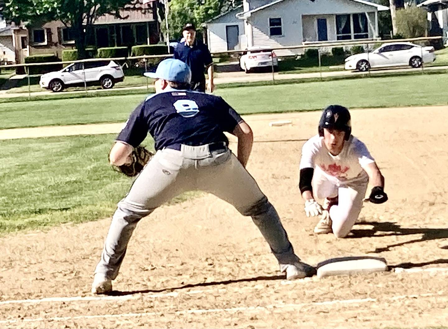 Hall's Luke Bryant dives back into first base in Monday's game at Foley Field. The Hall freshman had three hits in the Red Devils' 9-0 win over Bureau Valley.