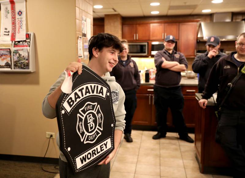 Brice Worley, 16, a junior at Batavia High School, shows a gift he received at the Batavia Fire Department’s Wilson Street Station. The wood plaque was handcrafted by a Batavia firefighter. Worley was born with a brain tumor that was dormant until 2019. He hopes to study to become a paramedic.