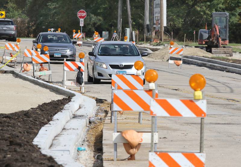 Vehicles pass road construction as they head west on Twombly Road near North Annie Glidden Road Thursday, Oct. 7, 2021, in DeKalb. This is one of the many road projects ongoing or recently completed in the county.