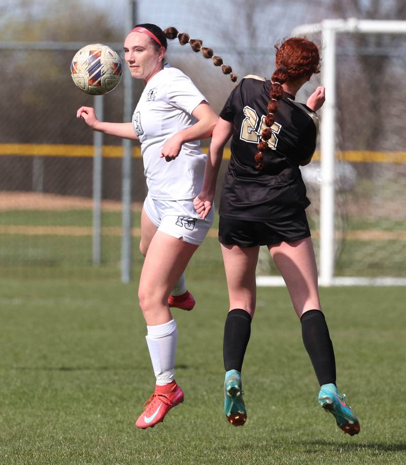 Kaneland's Kyra Lilly (left) and Sycamore's Isabelle Segreti try to win the ball in the air during their game Monday, April 14, 2025, at Sycamore High School.