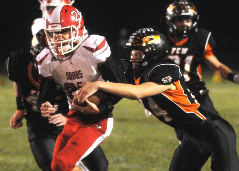 Flanagan-Cornell/Woodland's Zander Radke gets his hands on South Beloit quarterback Landen Reed at Woodland on Friday, Oct. 13, 2023.