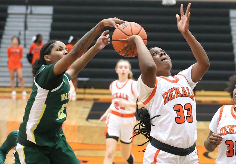Waubonsie Valley's Taylor Curry blocks the shot of DeKalb's Cayla Evans during their game Thursday, Dec. 15, 2022, at DeKalb High School.
