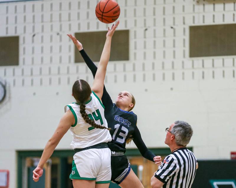Oswego East's Cassie Van Meter (13) tips off against York's Olivia Silkaitis (34) in their York Thanksgiving Tournament game between Oswego East at York on Monday\, Nov 18, 2024  in Elmrst.