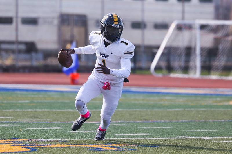 Joliet West’s Carl Bew rolls out to pass against Joliet Central on Saturday.