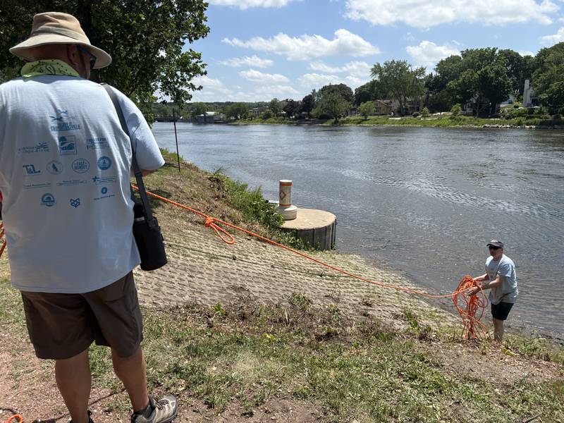 Event personnel remove a rope from the finish point of the "El Cardunal" paddle in East Dundee June 22, 2025.