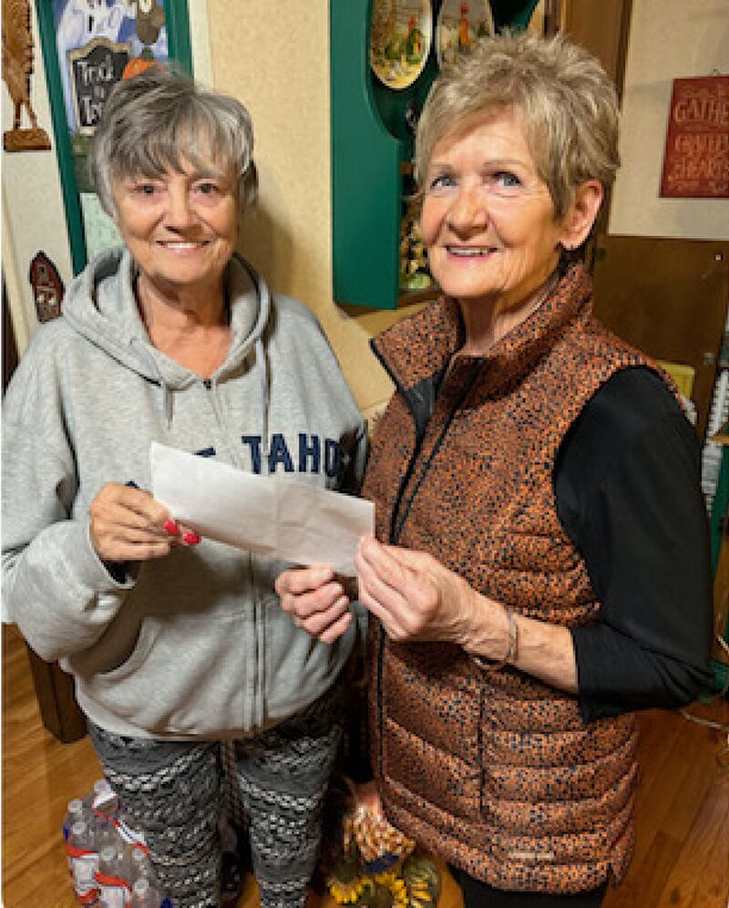 Cathy Oliveri and Kathy Kline receive a $2,000 check from the Spring Valley Toy Run for the Toys in the Pantry.