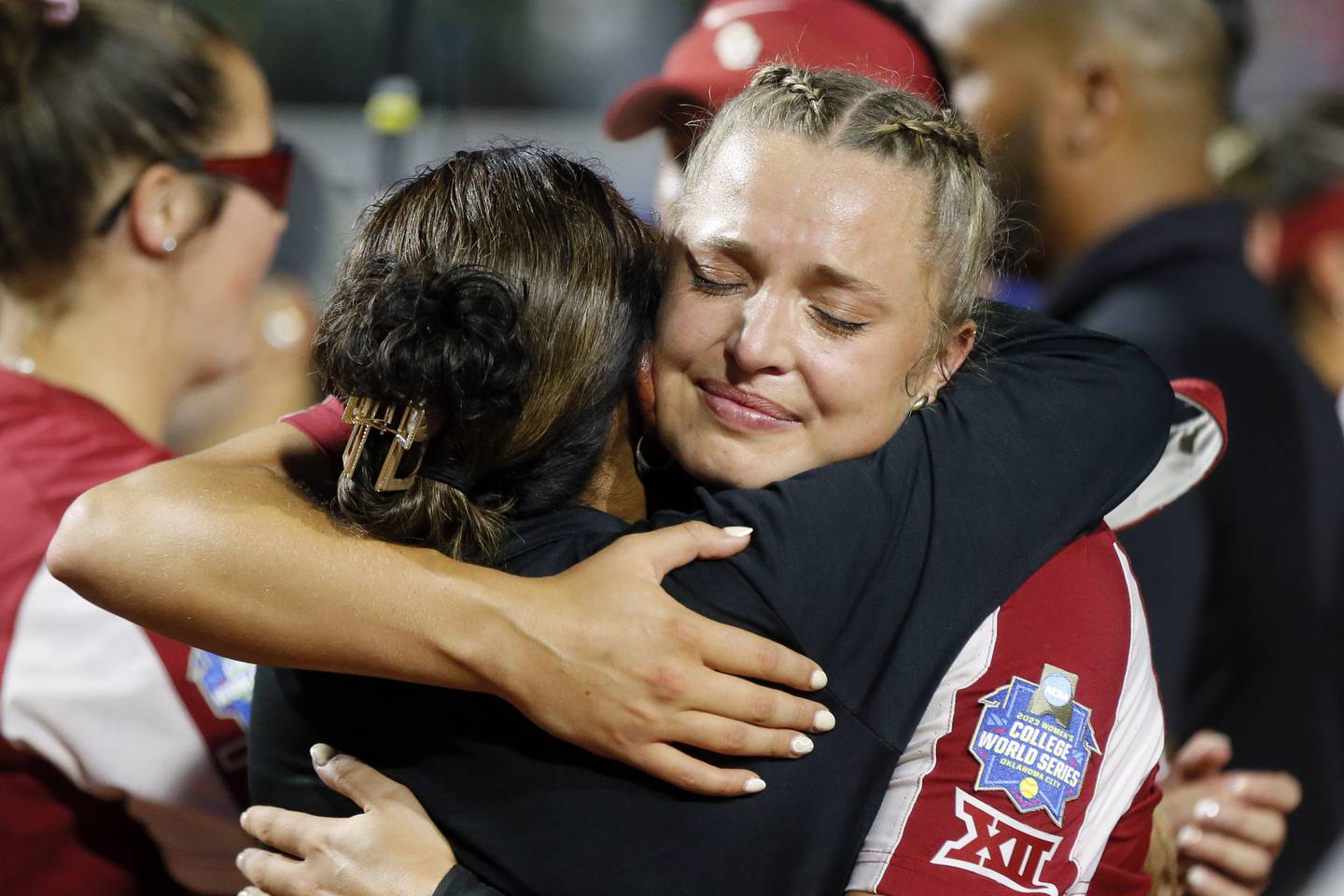 Oklahoma's Alex Storako hugs associate head coach Jennifer Rocha after the team's win over Florida State in the NCAA Women's College World Series softball championship series Thursday, June 8, 2023, in Oklahoma City.