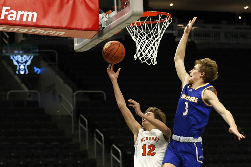 McHenry's Caleb Jett drives to the basket against Johnsburg's Dylan Schmidt during a non-conference basketball game Sunday, Nov. 27, 2022, between Johnsburg and McHenry at Fiserv Forum in Milwaukee.