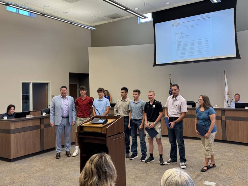 Morris Mayor Chris Brown with the members of the Morris Community High School Hydrogen Car Club, who are traveling to Germany later this month.