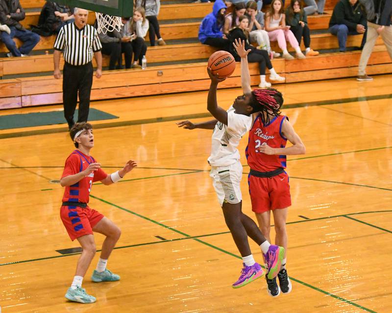 Glenbard West's Teyion Oriental (11) gets a shot off during the second quarter after getting past Glenbard South's Ben Zima (22) on Monday Nov. 20, 2023, district 87 invite held at Glenbard West.