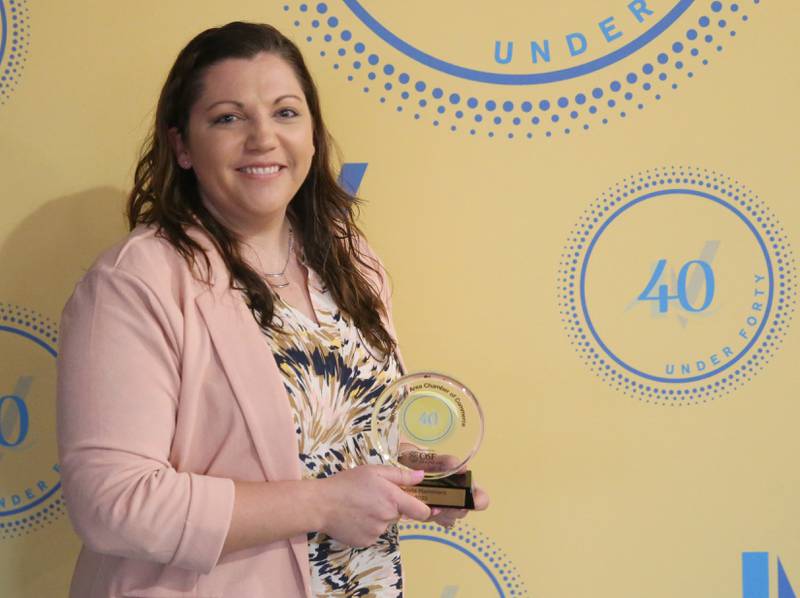 Heather Smith poses for a photo with her award during the 40 Under Forty awards banquet on Thursday, March 21, 2024 at Westclox in Peru.