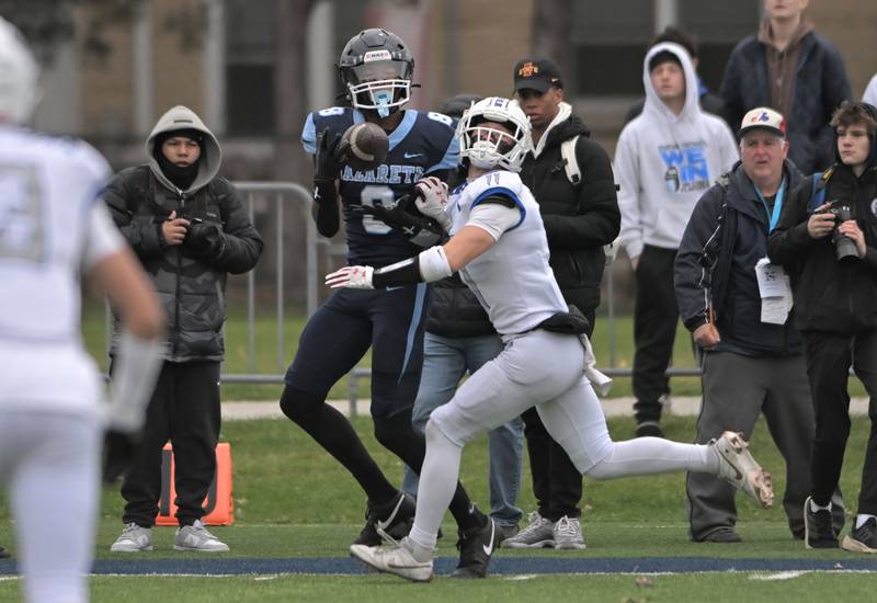 Nazareth’s Trenton Walker catches a touchdown pass in the first quarter as St. Francis’ Tanner Glock defends in the IHSA Class 5A state semifinal football game in La Grange on Saturday, Nov. 23, 2024.