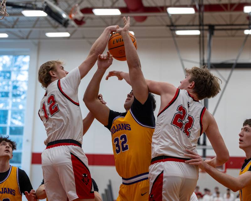 Cam Wasmer (32) of Mendota goes up for layup but is blocked by Hunter Edgcomb (12) of hall and guarded by Ben Giachetto (22) of Hall in the championship game of the Colmone Classic on Saturday, December 20, 2025 at Hall High School in Spring Valley.