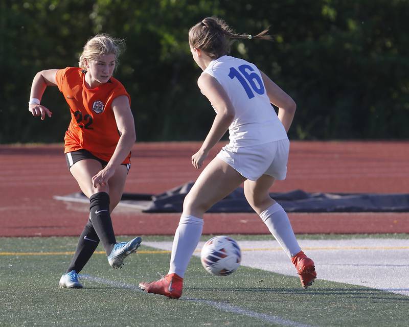 Crystal Lake Central's Olivia Anderson kicks the ball towards the goal as she is defended by Lake Forest's Chloe Hvostik during a Class 2A Deerfield Sectional semi-final match on Tuesday, May 21, 2024, at Deerfield High School.