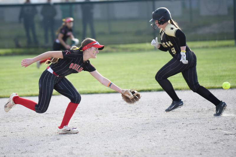 Bradley-Bourbonnais' Shannon Lee, left, watches a ball sneak by up the middle as Bishop McNamara's Reagan Kaner runs to third base during a game at Bishop McNamara Thursday, May 7, 2026.