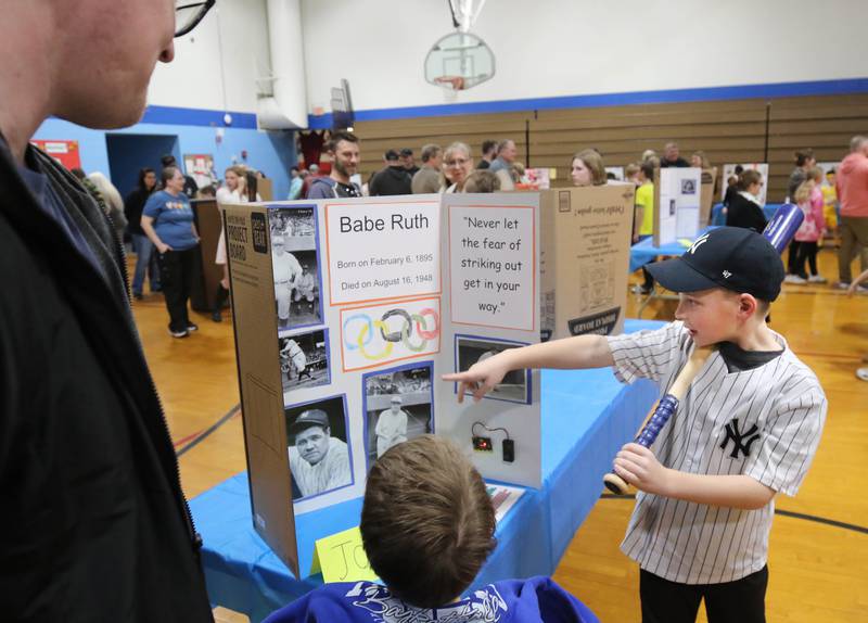 Visitors listen to third grader Jonah DeGroot, who is portraying Babe Ruth, as he gives his presentation during the Hinckley Big Rock Elementary School Wax Museum Thursday, March 13, 2025, at the school in Hinckley.