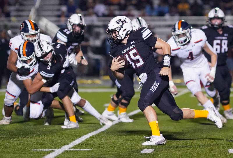 Plainfield North's Nicholas Darwish (15) runs the ball on a keeper against Oswego during a football game at Plainfield North High School on Friday, Sept. 22, 2023.