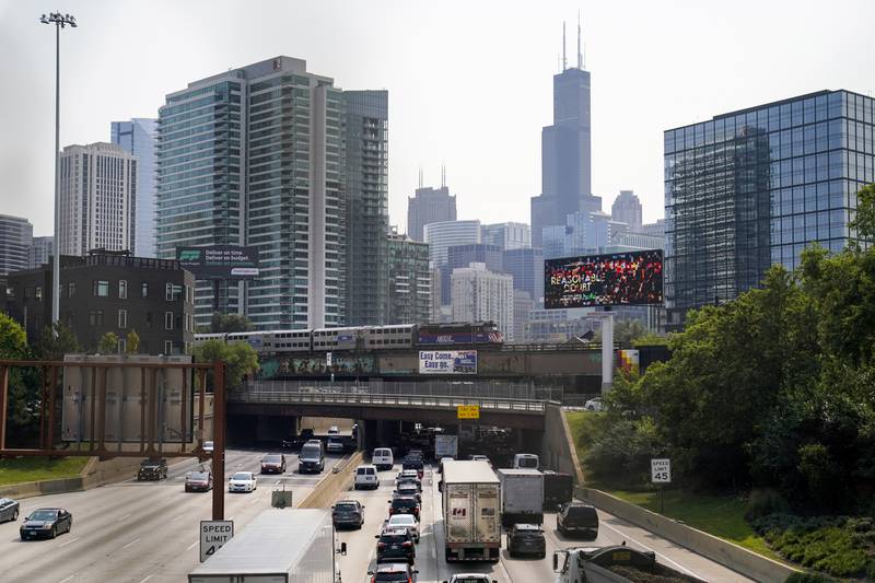 A Metra commuter train operated by Illinois' Regional Transportation Authority travels to downtown Chicago over Kennedy Expressway on interstate 90 and 94 Wednesday, Sept. 14, 2022, in Chicago. Business and government officials are preparing for a potential nationwide rail strike at the end of this week while talks carry on between the largest U.S. freight railroads and their unions. (AP Photo/Kiichiro Sato)
