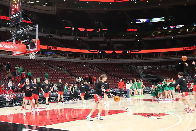 Members of the Streator boys basketball team warm up against Seneca during a game on Tuesday, Dec. 21, 2023 at the United Center in Chicago.