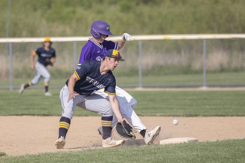 Sterling’s Mason Smithee can’t come up with a wild throw on a pick-off attempt against Rochelle in class 3A regional action on Monday, May 22, 2023.
