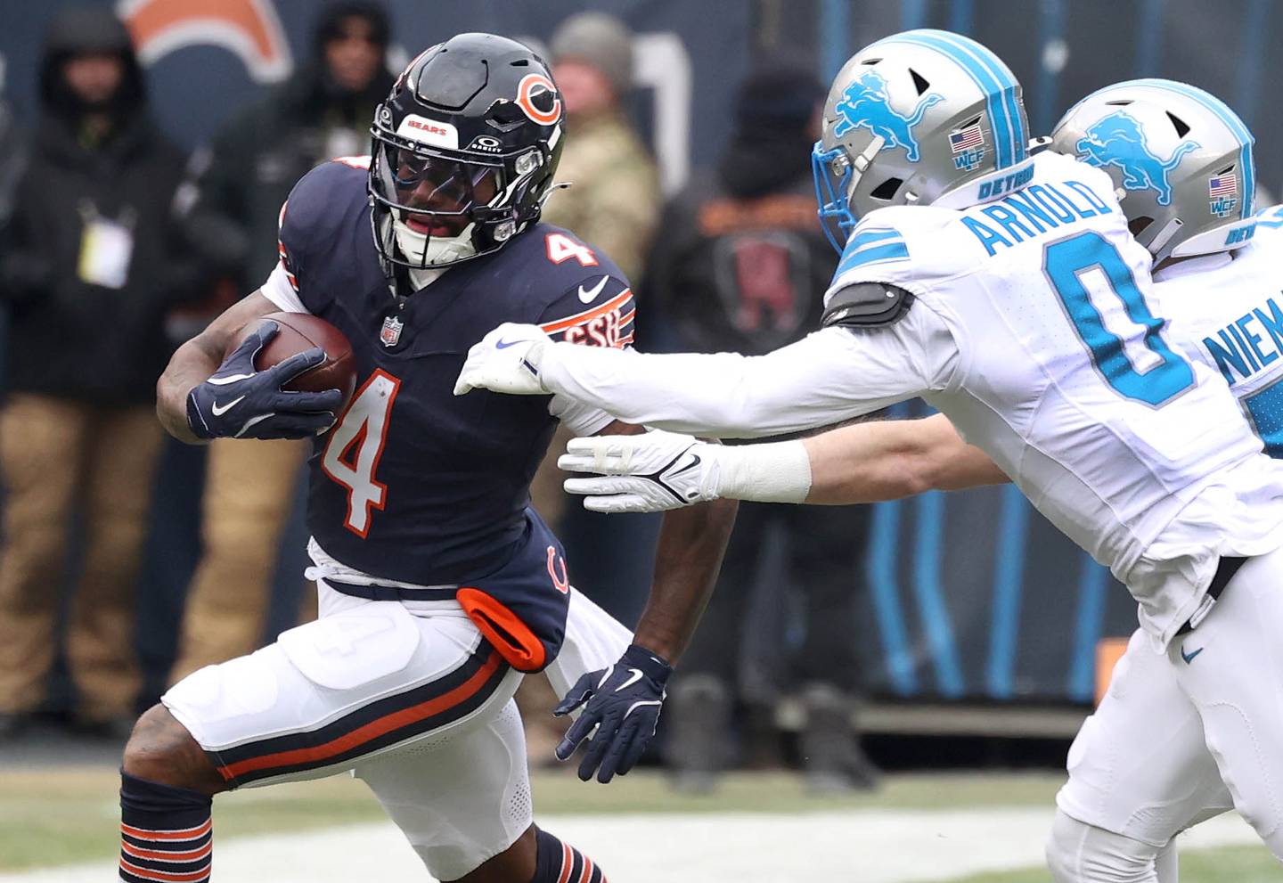 Chicago Bears running back D'Andre Swift tries to get outside of Detroit Lions cornerback Terrion Arnold and linebacker Ben Niemann during their game Sunday, Dec. 22, 2024, at Soldier Field in Chicago.