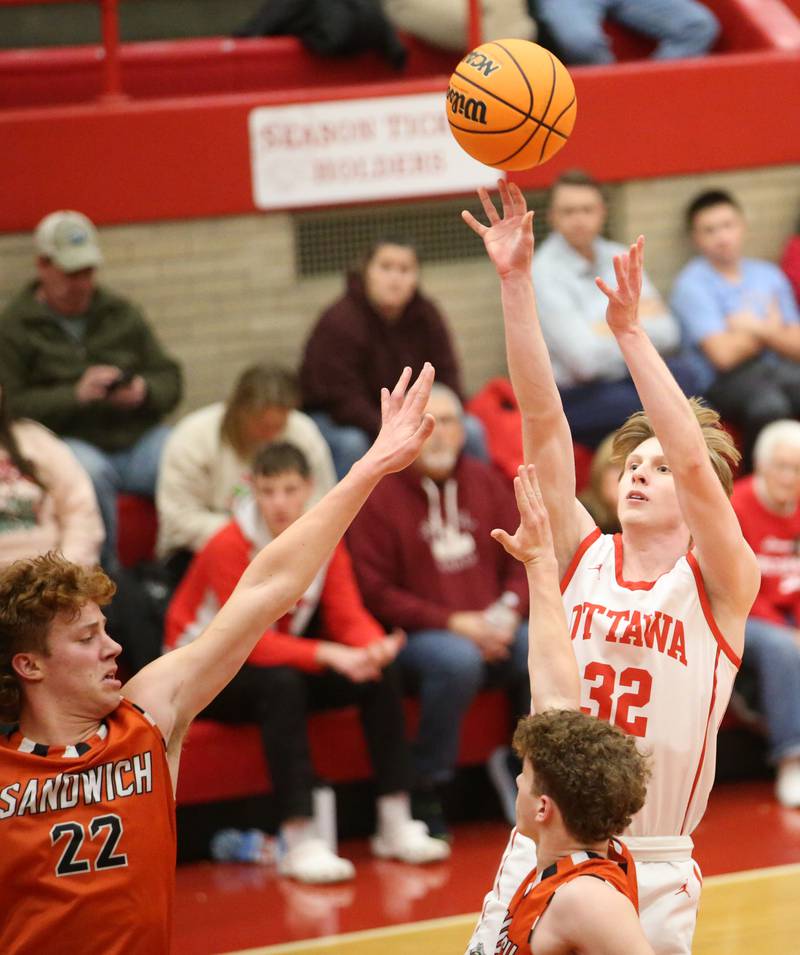 Ottawa's Aric Threadgill lets go of a jump shot over Sandwich's Dom Rome on Wednesday, Dec. 4, 2024 in Kingman Gym at Ottawa High School.