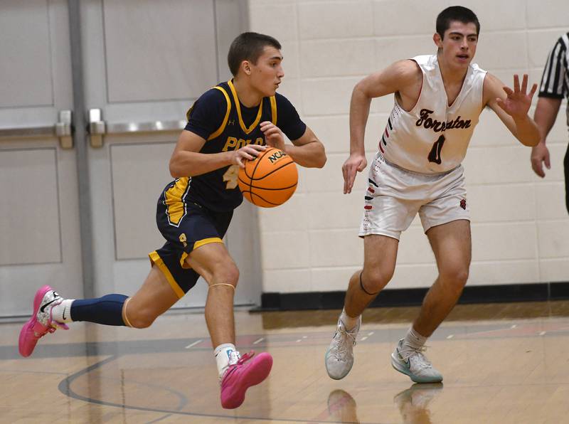 Polo's Mercer Mumford drives against Forreston's Brady Gill on Saturday, Dec. 13, 2025 at the 64th Annual Forreston Holiday Basketball Tournament held at Forreston High School.