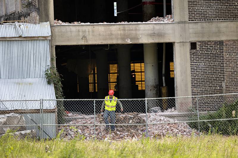 A crew member is seen working at the Micro Industries building in Rock Falls Wednesday, Aug. 7, 2024.