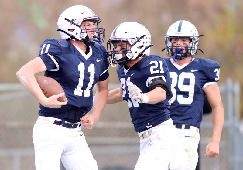 Cary-Grove’s Peyton Seaburg, left celebrates a touchdown as Ben Roseland, center, and Holden Boone greet him against Belvidere North in IHSA Class 6A quarterfinal playoff football action on Saturday, Nov. 16, 2024, at Al Bohrer Field on the campus of Cary-Grove High School in Cary.