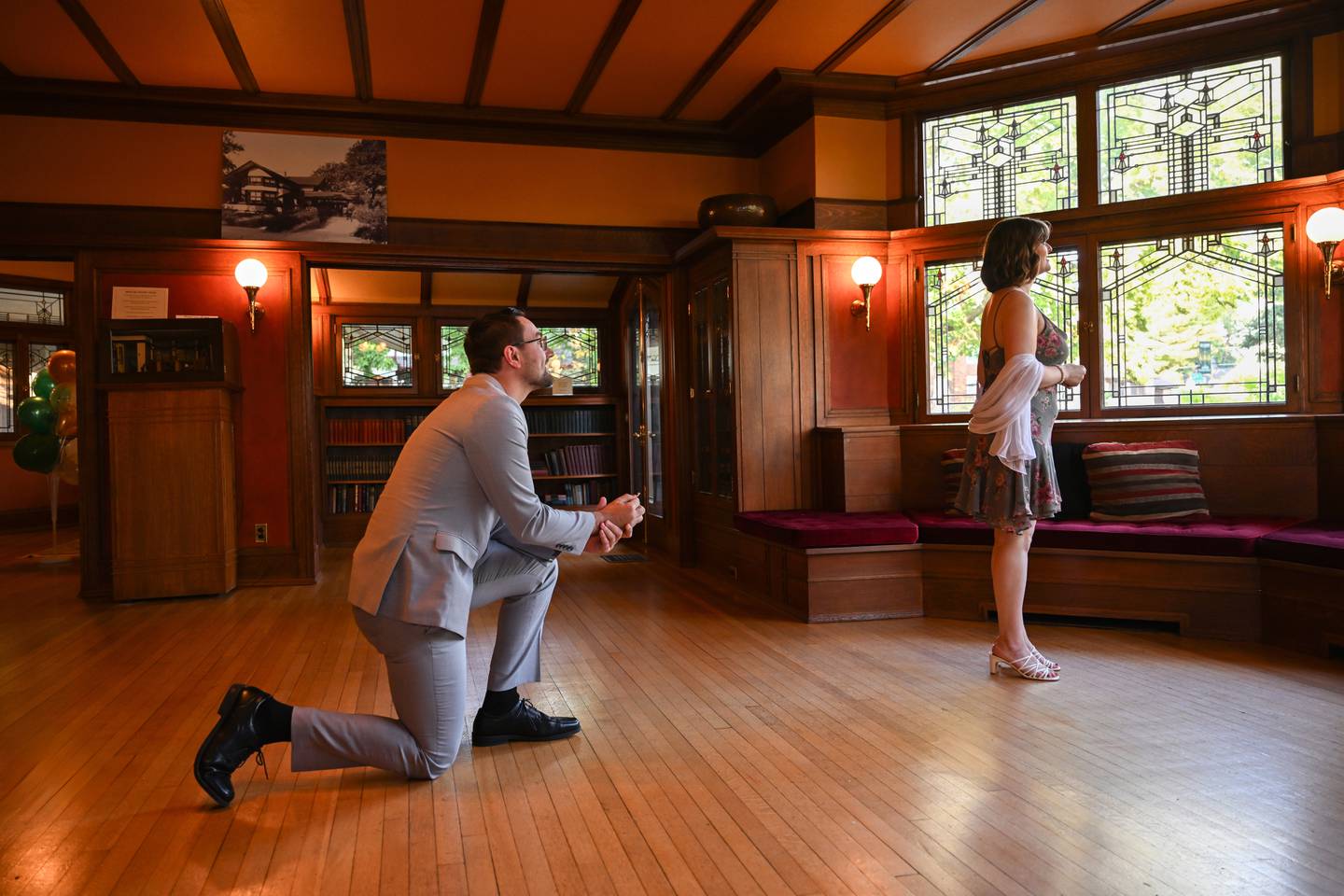 Colin Furrow, of Limestone, gets down on one knee to propose to girlfriend Karilyn Ross, of Moweaqua, as she remains unaware of the surprise waiting over her shoulder. The proposal took place, with the aid of the staff at the B. Harley Bradley House, on Saturday, Oct. 4th, 2025.