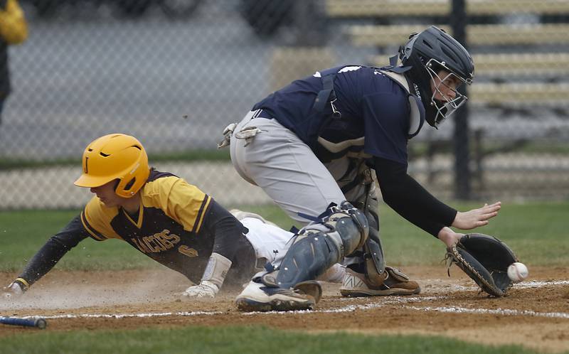 Cary-Grove's Jake Hornok fields the trow as Jacobs's Caden Guenther slides into home during a Fox Valley Conference baseball game Thursday, May 5, 2022, between Jacobs and Cary-Grove at Jacobs High School.