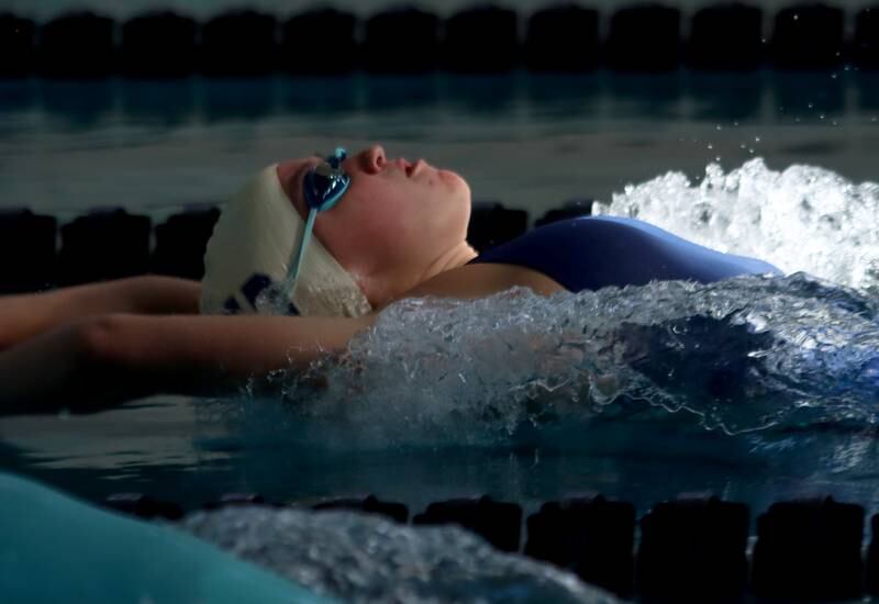 Cary-Grove’s Emma Black begins the 100-yard backstroke during the Fox Valley Conference Championship Meet at Woodstock North High School on Saturday, Nov. 2, 2024 in Woodstock .