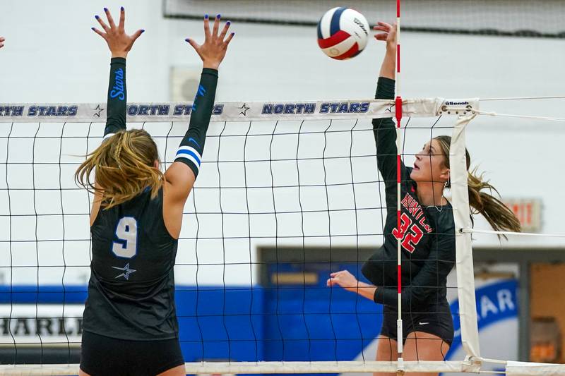 Huntley’s Izzy Whitehouse (32) goes up for a kill against St. Charles North's Ellie Sutter (9) during a non-conference match at St. Charles North High School on Wednesday, Sept. 3, 2025.