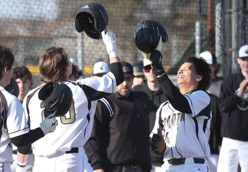 Sycamore's Tommy Townsend (right) is greeted by teammates at home plate after hitting a 3-run home run during their game against Harlem Monday, March 27, 2023, at the Sycamore Community Park.