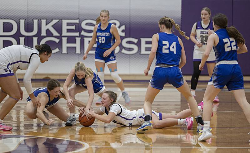 Dixon and Princeton players scramble for a loose ball Thursday, Jan. 4, 2024 at Dixon High School.