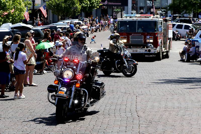 McHenry County Sheriff deputies ride their motorcycles around the Woodstock Square during the Woodstock VFW Post 5040 City Square Memorial Day Ceremony and Parade on Monday, May 29, 2023, in Woodstock.