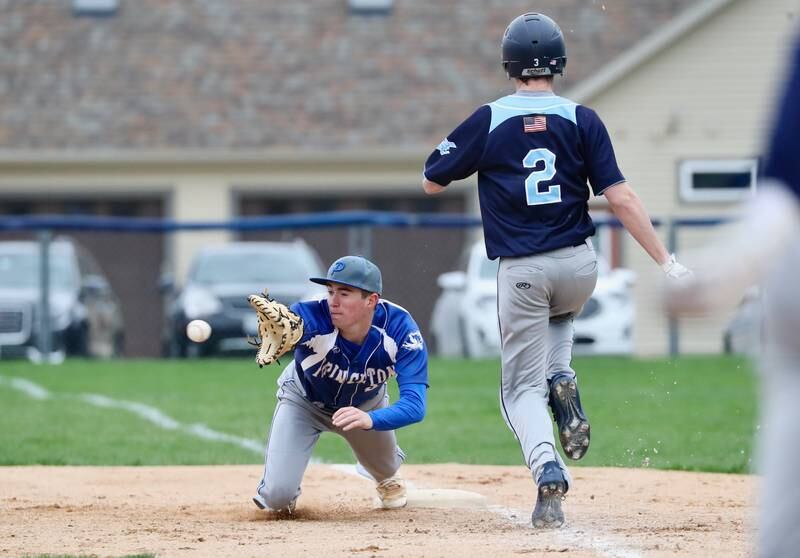 Princeton's Ean Compton reaches for a throw to first base as Bureau Valley's Cooper Balensiefen runs down the line.