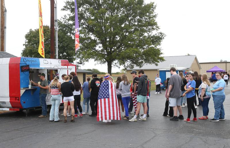Putnam County High School Students wait in a food truck line during the first annual Homecoming Parking Lot Party and Food Truck Festival on Monday, Sept. 23, 2024 at Putnam County High School. The Putnam County High School Student Council and the Work-Based Learning Program came up with the idea.