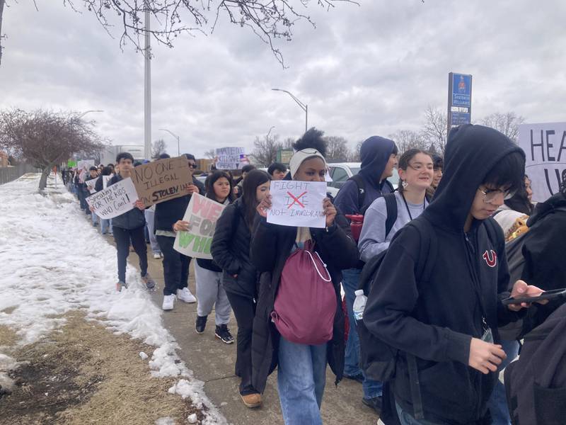 Students from Joliet West High School hold signs as they march down Larkin Avenue after walking out of school to protest the actions of Immigration and Customs Enforcement agents on Friday, Feb. 6, 2026.
