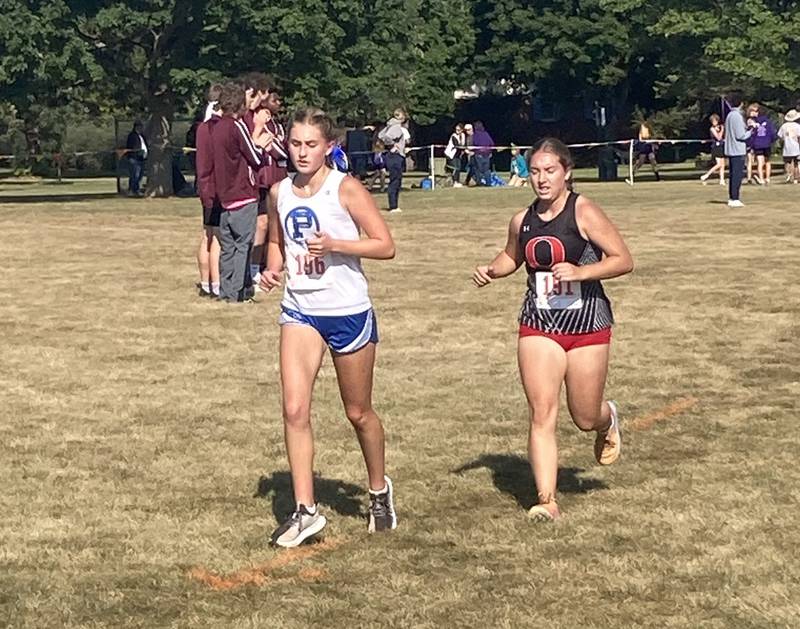 Princeton Avery Waca (left) runs in Saturday's Gary Coates Invitational at Zearing Park.