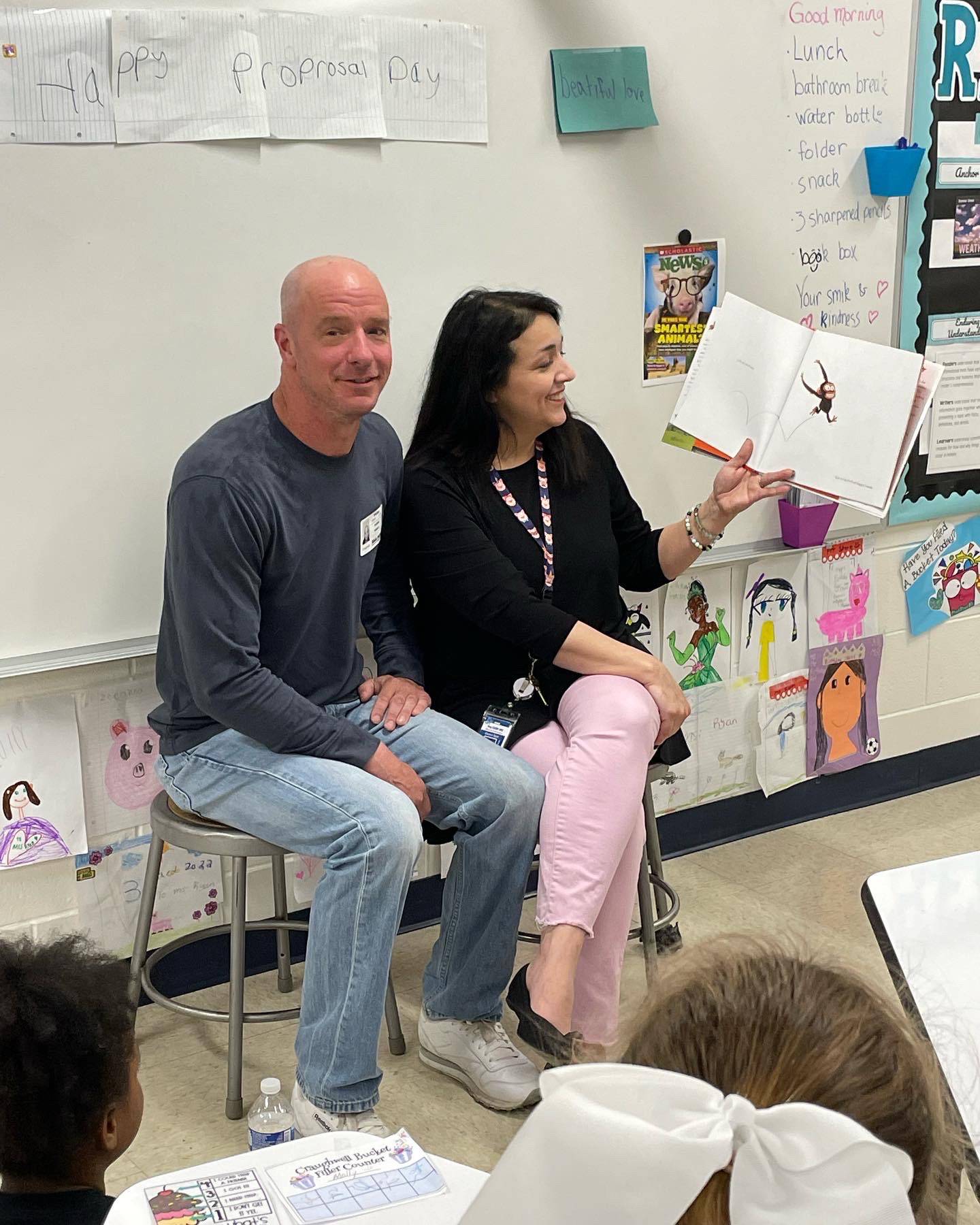 Tammy Ryan, a third grade teacher at Troy Craughwell Elementary School in Joliet, reads and records stories for her students at her friends farm that Ryan's students can watch later. Ryan (right) also hosts a live bedtime story reading each week, called Tuck in Tuesdays, with her boyfriend Tom Swartz (left). On Tuesday, March 22, 2022, Swartz proposed to Ryan during the reading. Ryan and Swartz are pictured in Ryan's classroom.