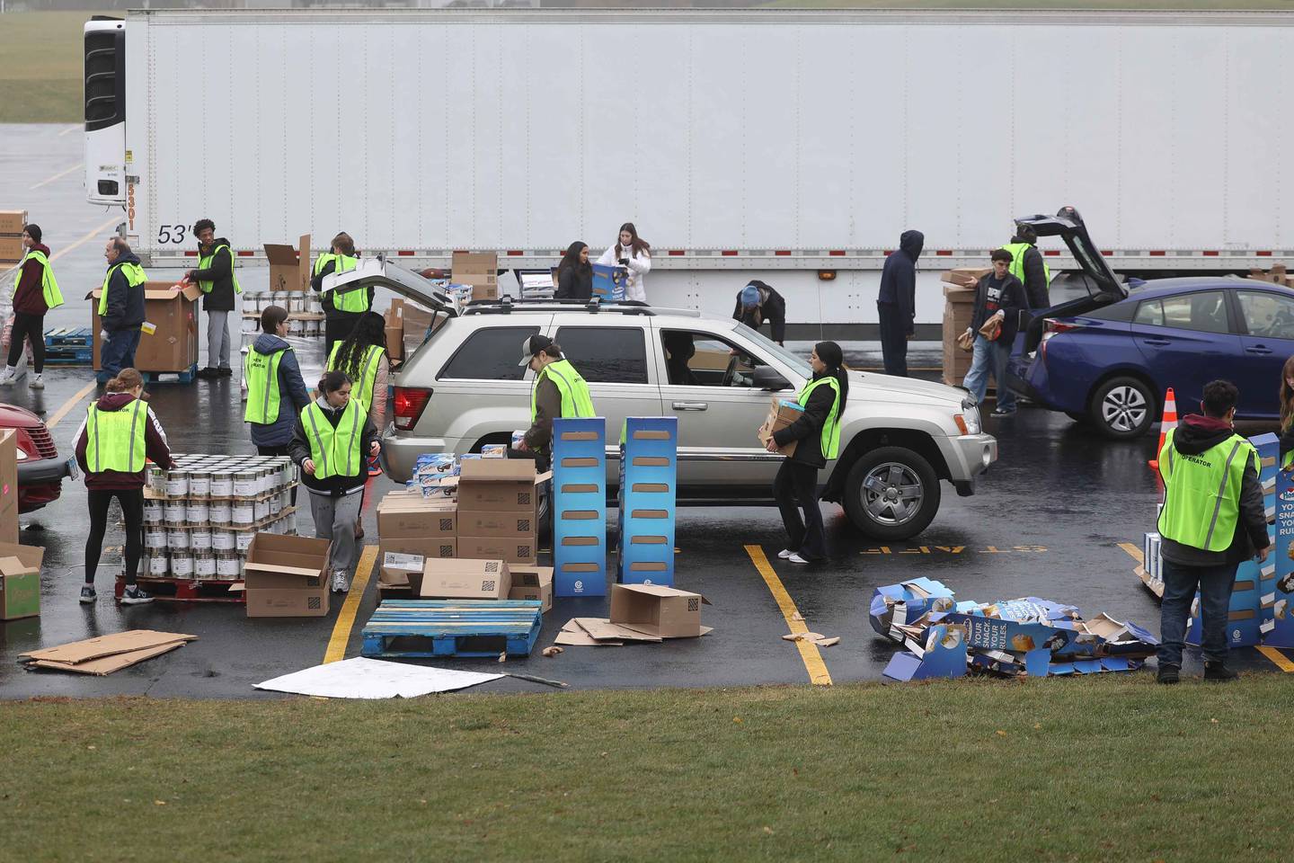 Volunteers load vehicles with food during ShareFest at Lockport Township High School East campus on Sunday, Dec. 15, 2024.