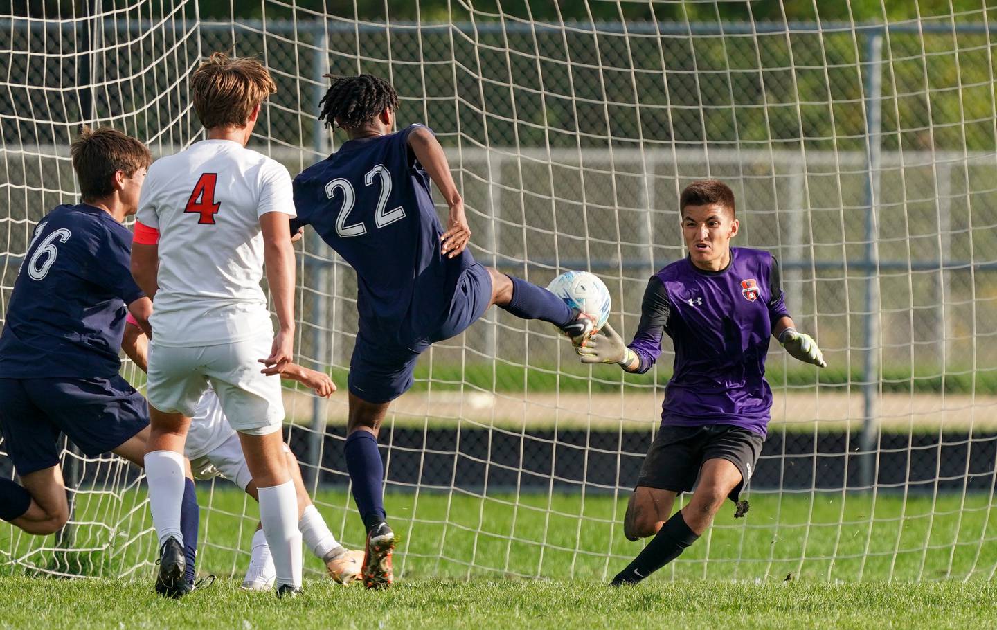 Oswego East's Marlin Hoffman (22) shoots the ball for a goal against Oswego’s Angel Moreno (1) during a soccer match at Oswego East High School on Tuesday, Sept. 26, 2023.