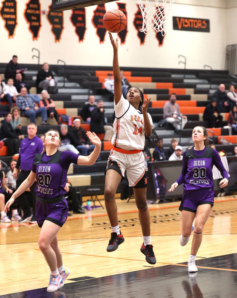 DeKalb’s Brytasia Long gets a layup between two Dixon defenders during their game Monday, Jan. 23, 2023, at DeKalb High School.