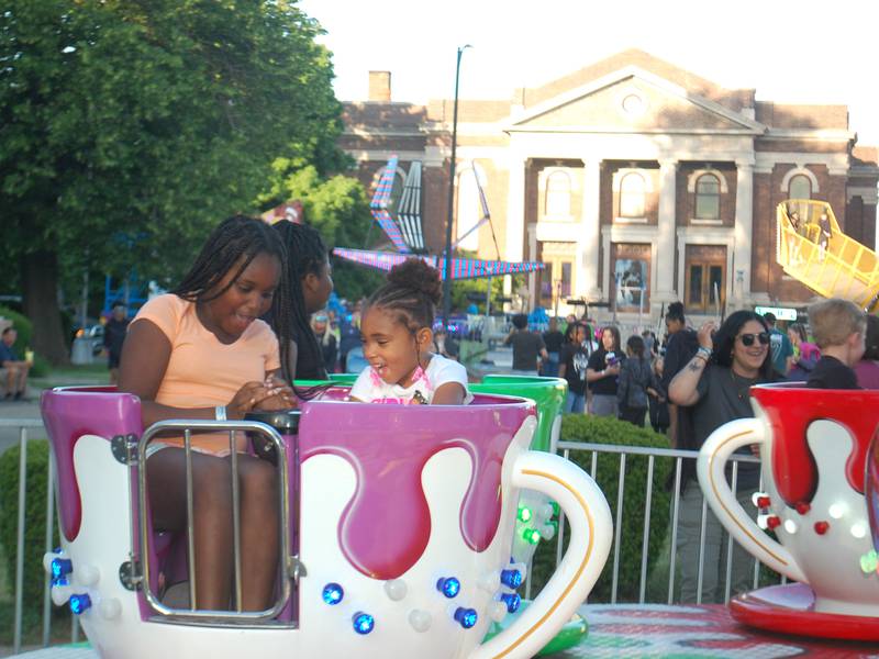 Children laugh as they spin on the teacup ride at Streator Park Fest on Friday, May 26, 2023.