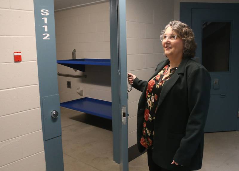 Bureau County Jail administrator Becky Gosch, holds open an empty jail cell on Tuesday, Jan. 28, 2025 at the Bureau County Jail in Princeton. The recent Bureau County Board resolution involves housing inmates from Cook County. About half of the inmates at the Bureau County Jail are not Bureau County residents.