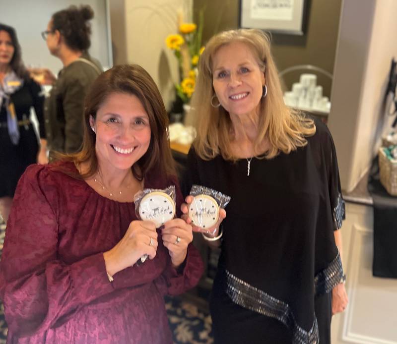 State Street Jewelers team members Shannon Stewart (left) and Wynn Fabbri Sept. 25, 2025, with cookies decorated to mark the 40th anniversary of the store in Geneva.
