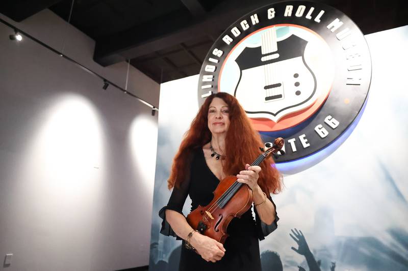 Violinist Scarlet Rivera, best known for her work with Bob Dylan on his 1976 album Desire and Rolling Thunder Revue tour, poses for a photo at the Illinois Rock and Roll Museum on Tuesday, Aug. 8, 2023 in Joliet.