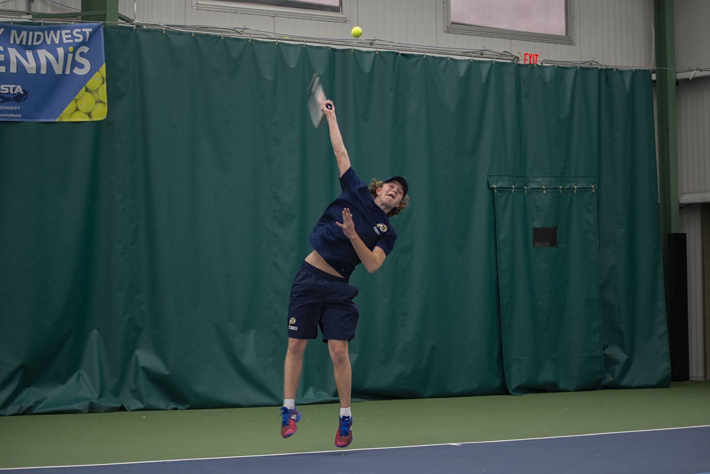 Sterling's Brecken Peterson serves to Rock Island's Joe Brune during a tennis meet at Westwood Thursday, March 31, 2022.