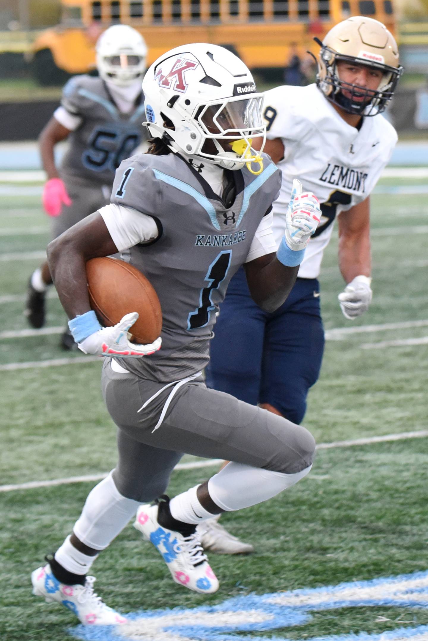Kankakee's Kymani Billings (1) runs past Lemont's Jackson Dybcio on his way for a 62-yard touchdown during an IHSA Class 5A playoff game at Kankakee Saturday, Nov. 1, 2025.